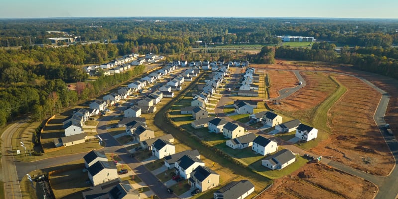 Aerial of suburban neighborhood with existing homes and new construction