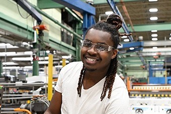 An S&C team member smiles for the camera