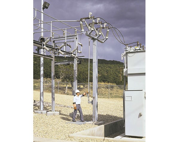 installed upright switch at an outdoor distribution substation and an operator swinging the operating handle Alduti-Rupter Switches - Outdoor Distribution, upright switch, no-external-arc circuit interruption, Alduti-Rupter Switches, Arc Compressor, controlled circuit interruption without external arc